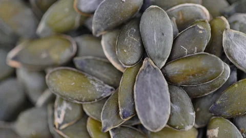 Close Up Of Pumpkin Seeds Rotating. Macro Shot Of Pumpkin Seeds. Vegan Food. Video stock 153609087