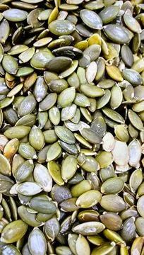 Close up pumpkin seeds surface showing organic plant based food texture Stock Photos