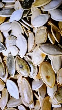 Close up pumpkin seeds surface showing organic plant based food texture Stock Photos