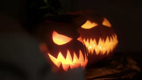 Close-up on pumpkins with carved evil faces for Halloween celebration Stock Footage 217949646