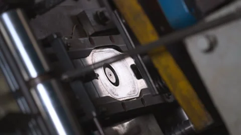 Close up of a punch press forming metal parts in a production line. Stock Footage 246921813