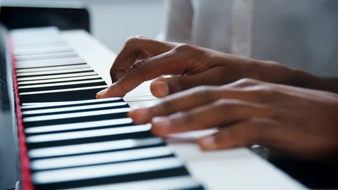 Close Up Of Pupil With Teacher Playing Piano In Music Lesson Stock Footage