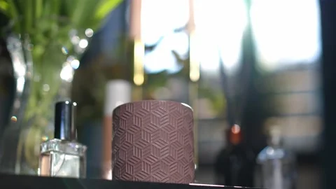 Close-up purple candle holder on table with cologne indoors. Domestic decoration Video stock 221863647