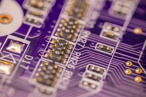 Close-up of a purple printed circuit board featuring various electronic com.. Stock Photos
