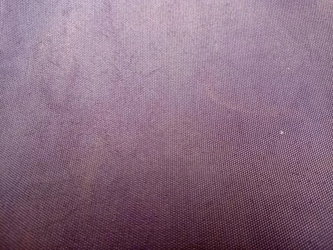Close up of purple textured fabric or canvas background with subtle gradien.. 스톡 사진