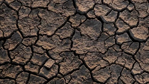 Close Up push Cracks drought soil crisis cross over a dried mud backgrounds Vídeo Stock 334030724