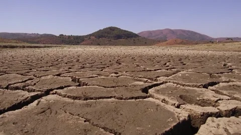 Close Up push Cracks drought soil crisis cross over a dried mud backgrounds Vídeo Stock 334030770