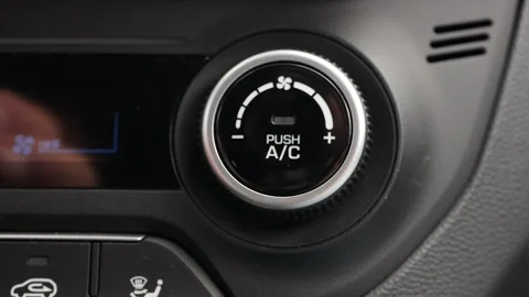 Close-up of pushing a button to turn on the air conditioner in a car. The mans Stock Footage 137498242