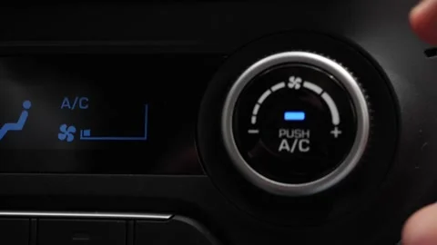 Close-up of pushing a button to turn on the air conditioner in a car. The mans Stock Footage 137498674