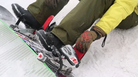 Close up to put a snowboard in the winter Stock Footage 73672371