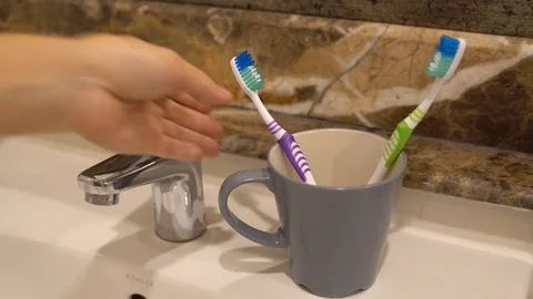 Close up put toothbrush back to the cup bathroom Video stock 111151734