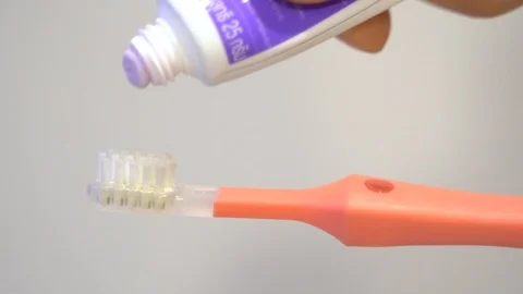 Close up put toothpaste on toothbrush for baby children kids toddler Stock Footage 111151727