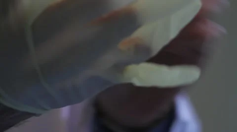 Close on putting on both rubber gloves Stock Footage 20447332