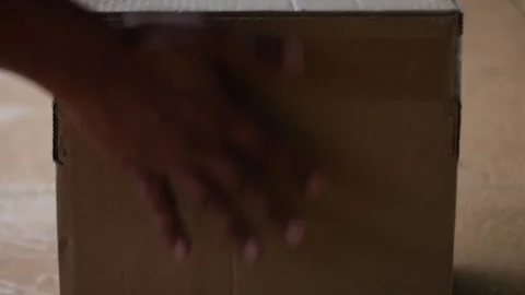 Close up of putting a brown box or package Stock Footage 327788176