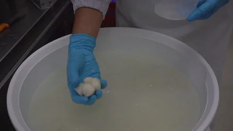 Close-up of putting cherry mozzarella in the package Stock Footage 129928166