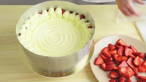 Close-up of putting mousse on strawberry cake cream. Stock Footage 132320495