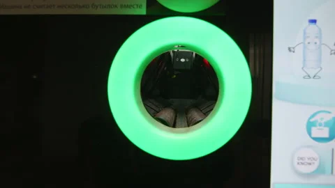 Close up putting plastic bottle in recycling system in the city Stock Footage 225401306