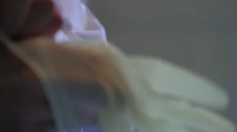 Close on putting on rubber glove Stock Footage 20447394