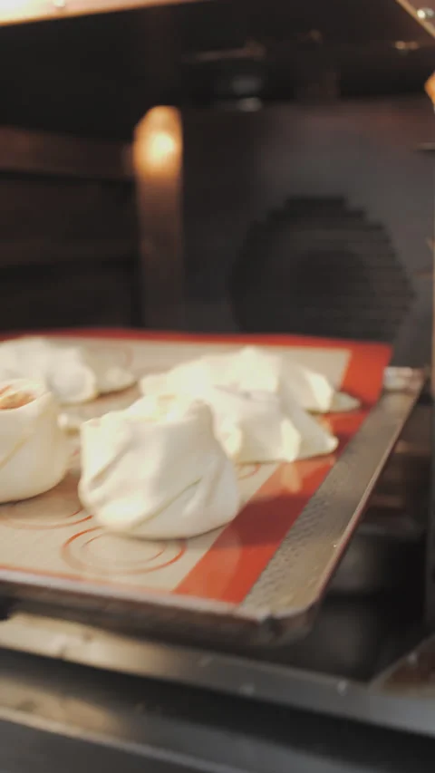 Close-up, putting a tray of dough into the oven for baking 스톡 동영상 345686498