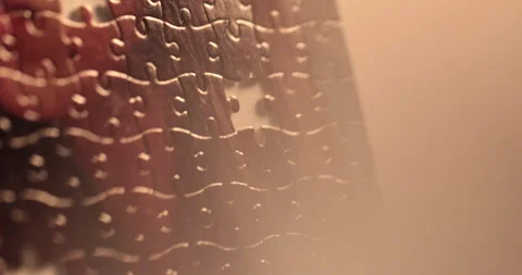 Close-up of the puzzle. A hand that puts a part of the puzzle. Stock Footage 240137554