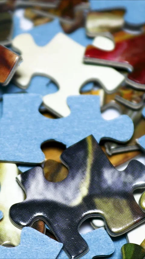 A close-up of a puzzle piece on a table Stock Footage 345168522