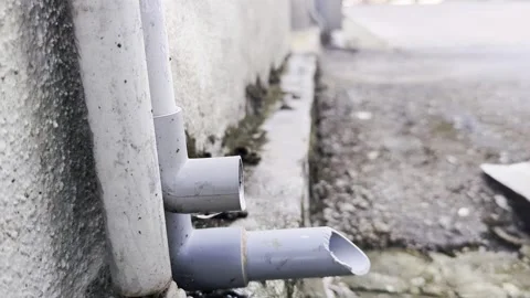 Close up of PVC Drain Pipe Water Output in Residential Outdoor Area Stock Footage 330574376