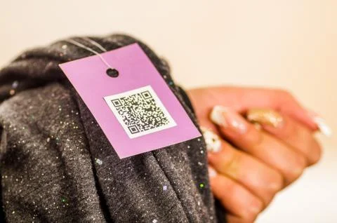 Close up of a QR code information in a clothes ticket in a blurred background Stock Photos