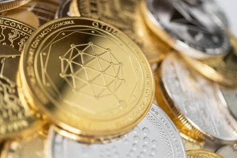 Close-up of qtum physical coin on stack of many other cryptocurrencies Stock Photos