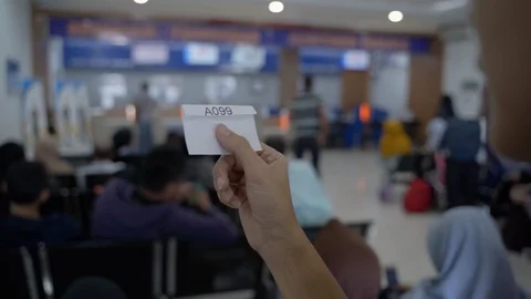 Close up of the queue number from a customers hand while waiting for a long time Stock Footage 105134020