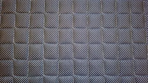 Close-Up of Quilted Fabric Texture with Small Polka Dot Pattern Stock Photos