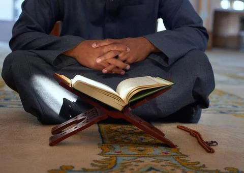 A close up of the Quran on a stand inside a mosque Stock Photos