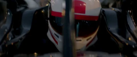 Close-up of a race car driver in a driving fast on a racing track, evening race Stock Footage 319491745