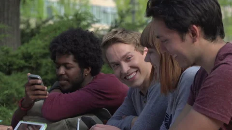 A close-up of racially-diverse students chatting at table Stock Footage 44117327