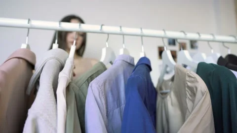 Close-up of Rack with clothe Girl Is Taking Her Shirt On A  Bar Video stock 148126544