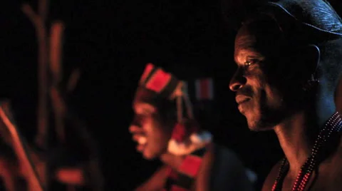 Close Up Rack Focus Between Two Members Of An Omo Valley Tribe Sitting By A Fire Stock Footage 66515922