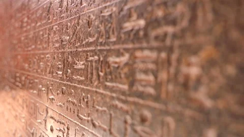 Close up rack focus of the egyptian hieroglyphs on the wall in The Museum in Stock Footage 251372087