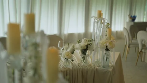 Close-up rack focus shot of burning pillar candles sitting on tall crystal Stock Footage 340920000
