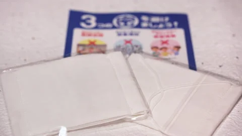 Close-up rack focus video of masks and COVID-19 leaflet sent by Japanese govt. Stock Footage 131224034