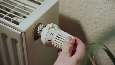 Close-up of a radiator, a hand is turning it off Stock Footage 236010533