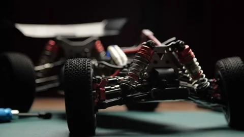 Close-up radio control model buggy car without shell rotating on cutting mat Stock-Footage 147426475