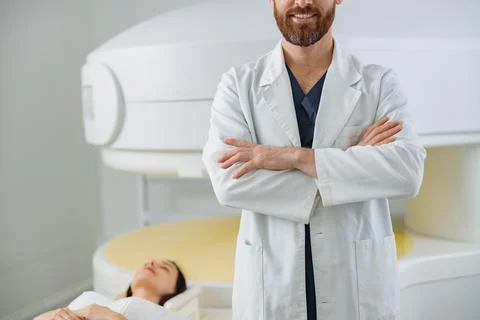 Close up of radiologist controls MRI or CT or PET Scan with female patient Foto stock