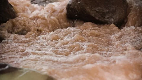 Close-up of a raging flood flowing through the rocks Stock Footage 292592511