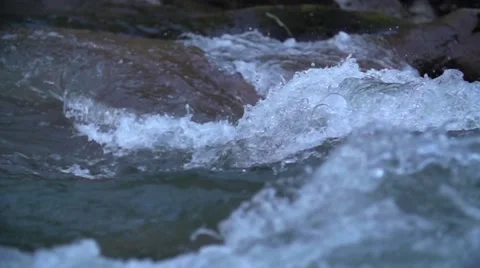 Close up raging water in the mountain river, Caucasus in slowmotion Stock Footage