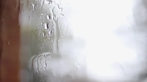Close up: Rail falls on window pane from inside home looking outside Stock-Footage 331112094