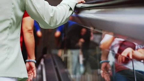 Close up Railing with hands People walking up escalator to the clear glass. 動画素材 114145086