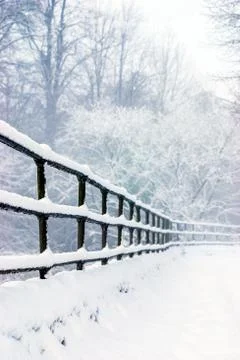 Close-up of railings covered in a soft layer of snow UK Stock Photos