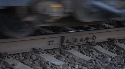 Close-up of railroad tracks moving under the weight of a passing train Stock Footage 54254547