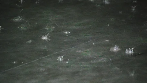 Close up of rain drop hit concrete floor cause splash Stock Footage 108618474