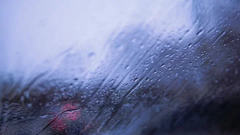 Close-up of Rain Drops and Water Streaks on Glass Window in Blue Moody Light Stock Footage 331785560