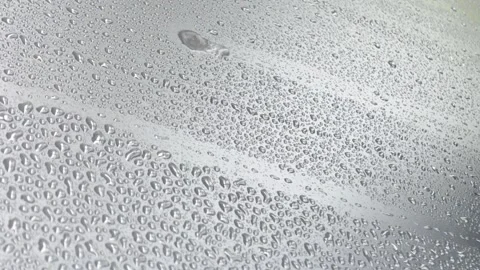 Close up of rain drops on black cover background. Stock Footage 295036917